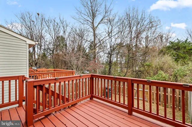 a balcony with wooden floor and trees