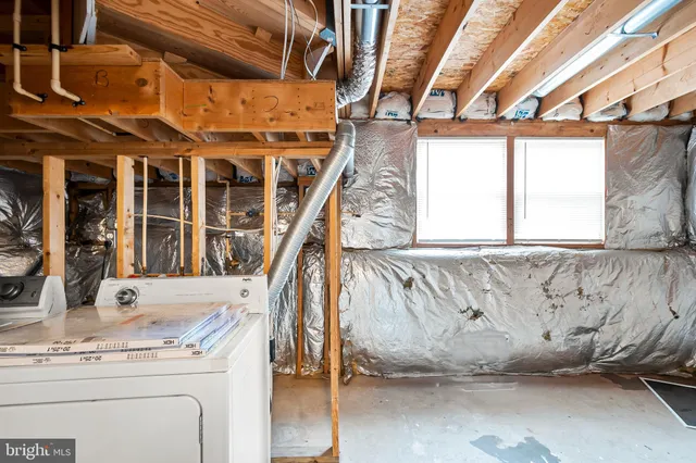 a view of walk in closet with window and stairs