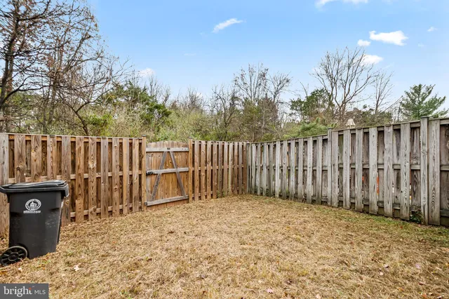 a backyard of a house with wooden fence