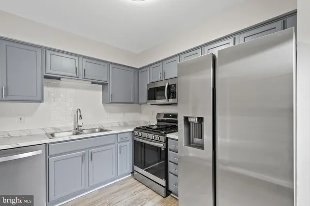 a kitchen with a refrigerator and a sink