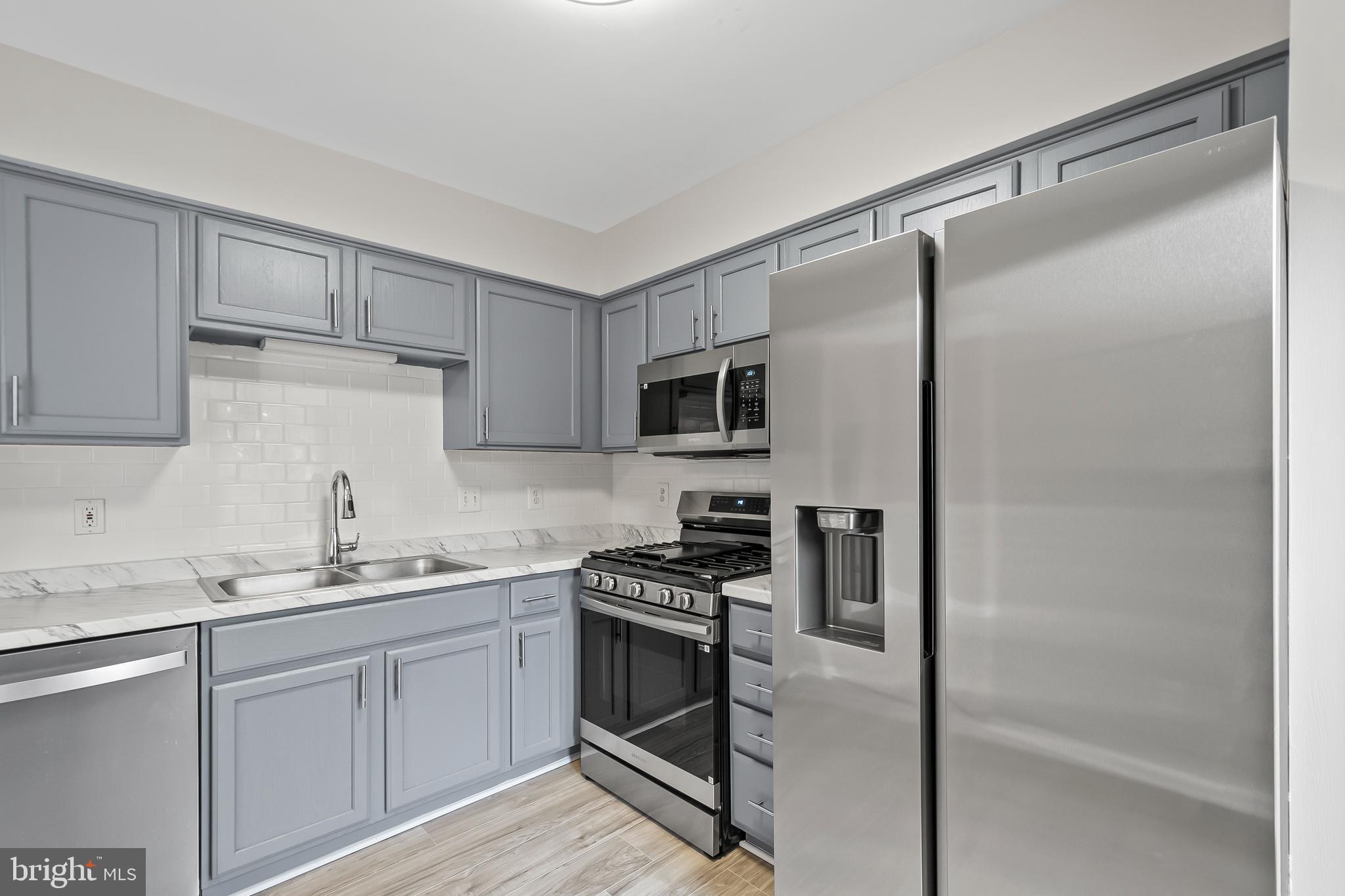 10305 Butternut Circle Manassas, VA 20110 - Photo 7 of 30 a kitchen with a refrigerator and a sink