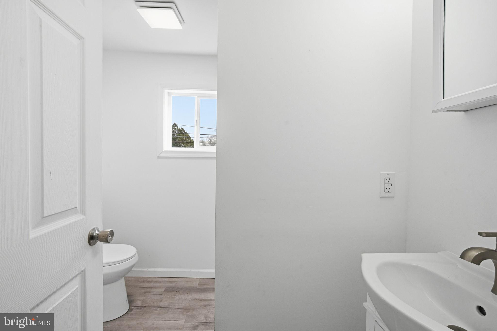 603 Academy Street Cambridge, MD 21613 - Photo 20 of 22 a bathroom with a sink and toilet