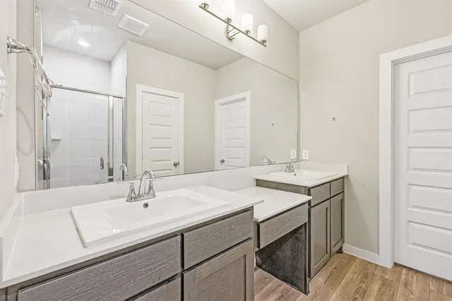 a en suite bathroom with a double vanity sink mirror and double