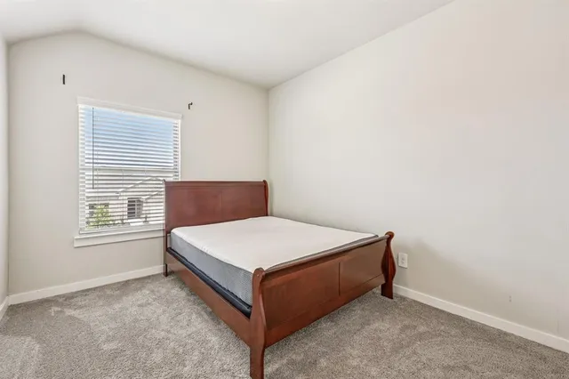 a bathroom with a sink a toilet and shower curtain