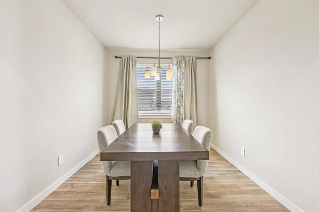 a kitchen with kitchen island a sink a stove a refrigerator and white cabinets