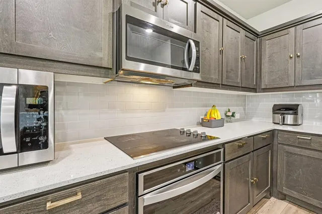 a kitchen with a sink a stove and cabinets