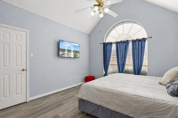 a bedroom with a bed and a chandelier
