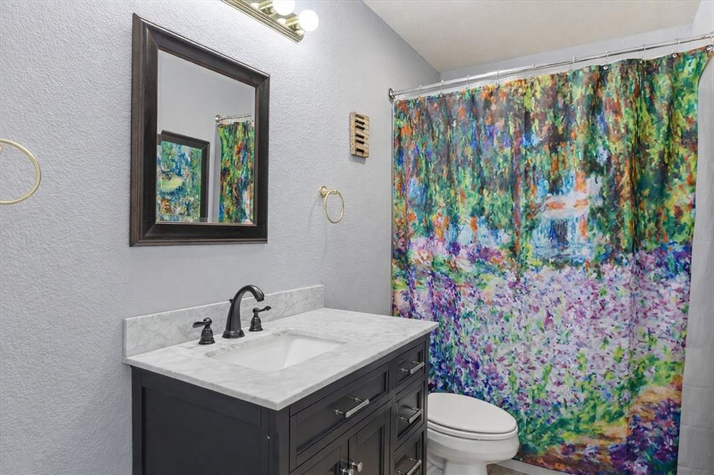 1636 Greenview Court Aledo, TX 76008 - Photo 20 of 30 a bathroom with a toilet sink and mirror