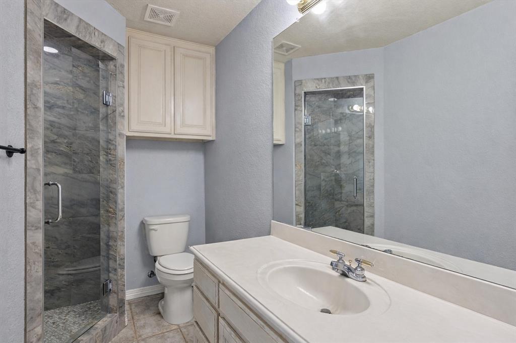 1636 Greenview Court Aledo, TX 76008 - Photo 22 of 30 a bathroom with a sink toilet and shower