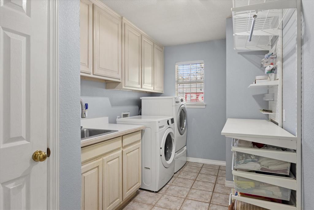 1636 Greenview Court Aledo, TX 76008 - Photo 23 of 30 a utility room with cabinets washer and dryer