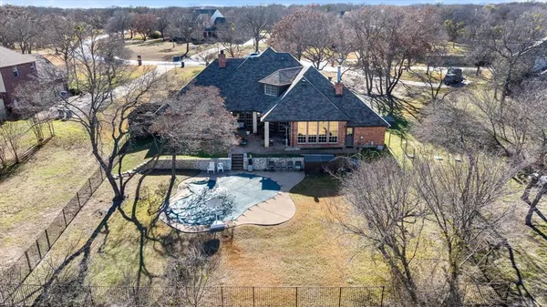 an aerial view of a house with yard and mountain view