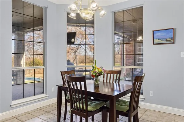 a view of a dining room with furniture and chandelier