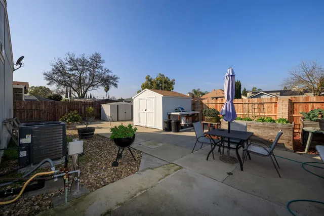 a view of a patio with table and chairs and potted plants