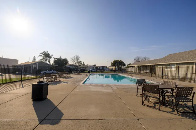 a park view with a bench and lake view