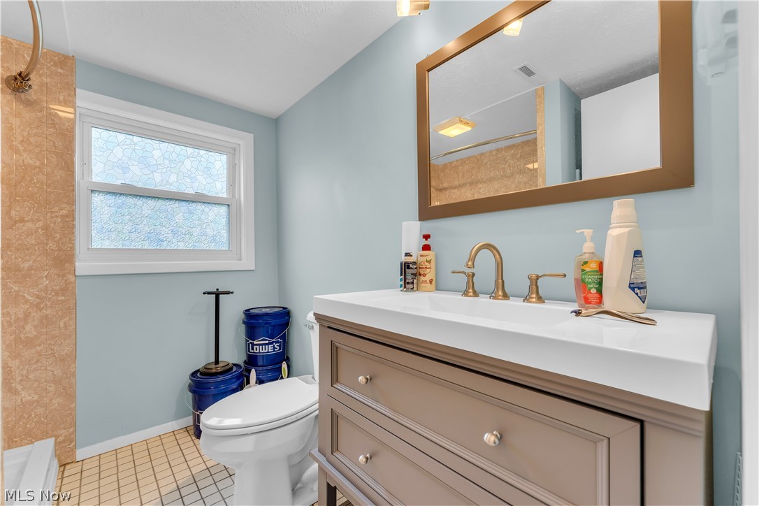 9642 Crow Road Litchfield, OH 44253 - Photo 35 of 50 Bathroom featuring large vanity, toilet, and tile flooring