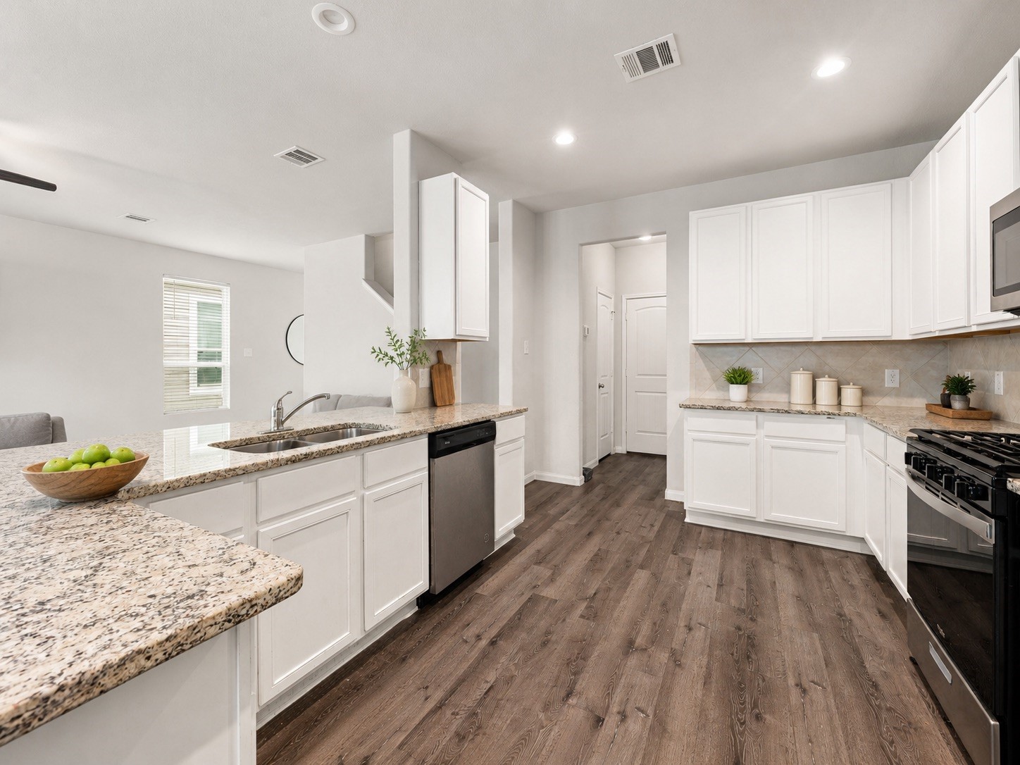 22210 Imperious Parkway Houston, TX 77073 - Photo 11 of 23 a kitchen with granite countertop wooden floors and white appliances