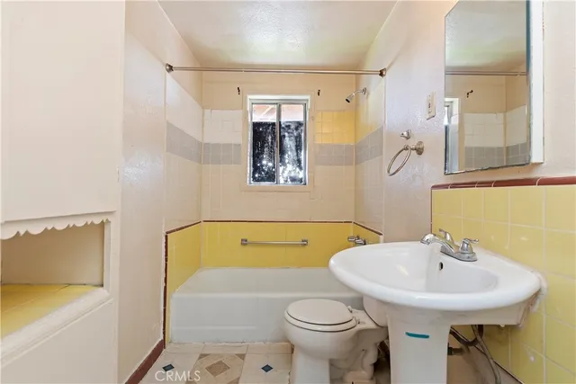 a bathroom with a sink a toilet and bathtub