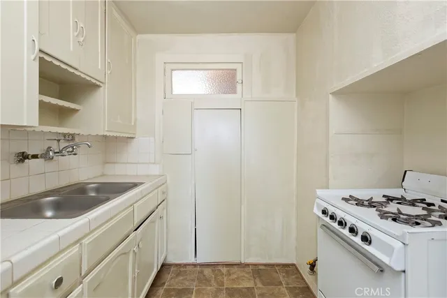 a kitchen that has a sink and a stove