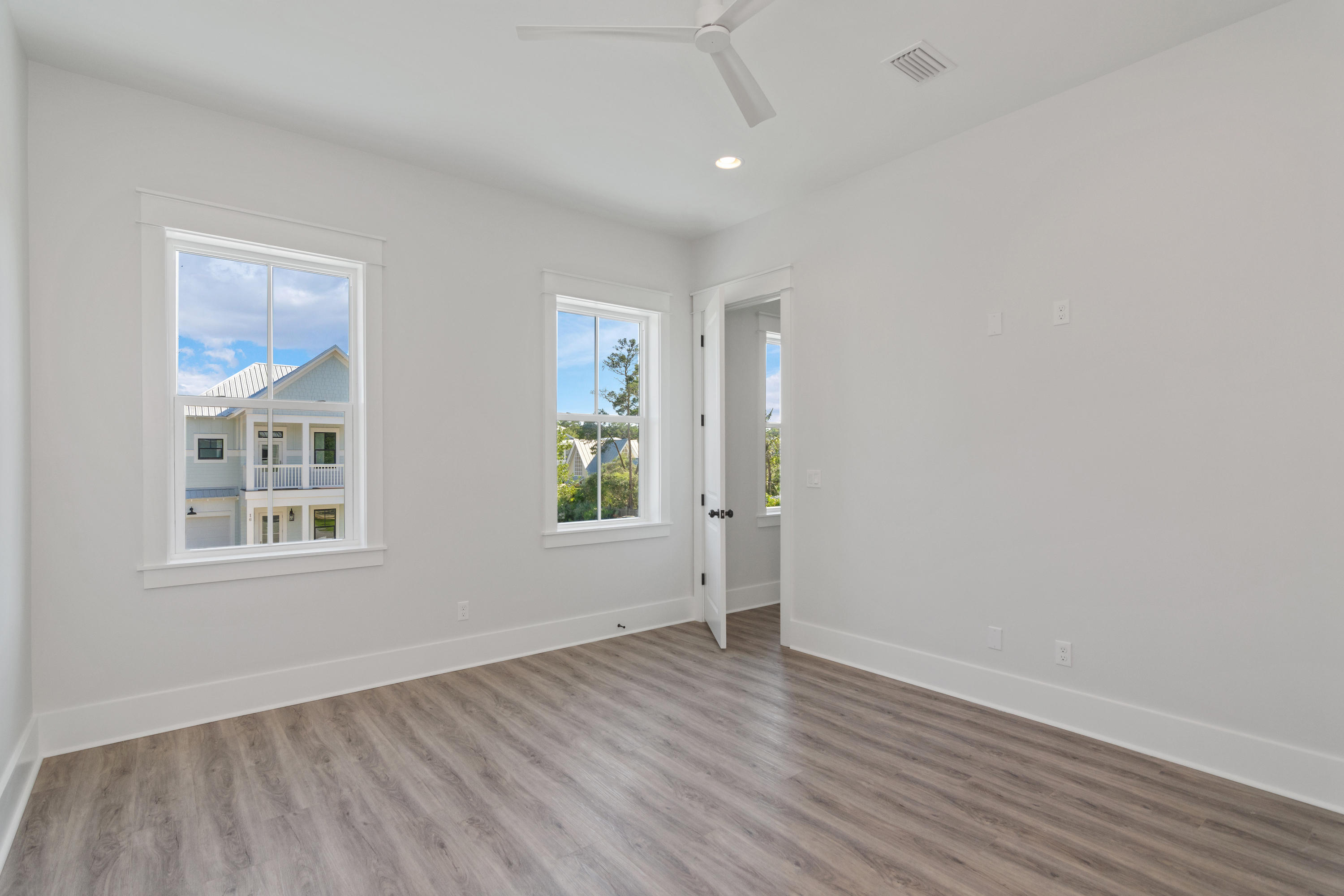 15 Lake Mist Ln Inlet Beach Inlet Beach, FL 32461 - Photo 25 of 48 an empty room with wooden floor and windows