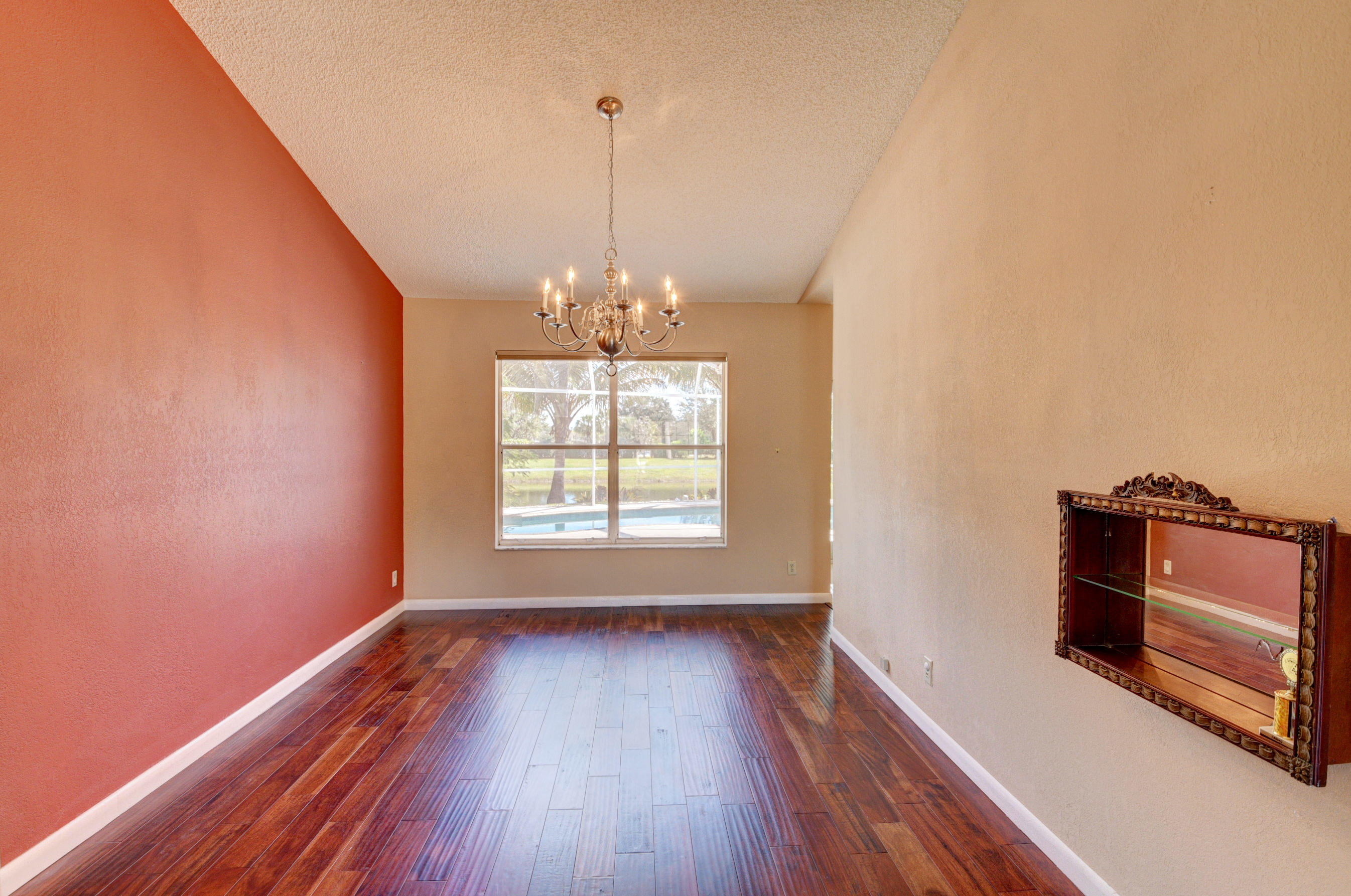 12059 Rockwell Way Boca Raton, FL 33428 - Photo 9 of 28 a view of an empty room with wooden floor and a window