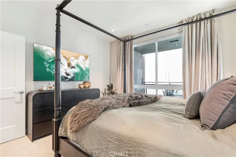 a bedroom with a large bed and a large window