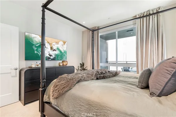 a bedroom with a large bed and a large window