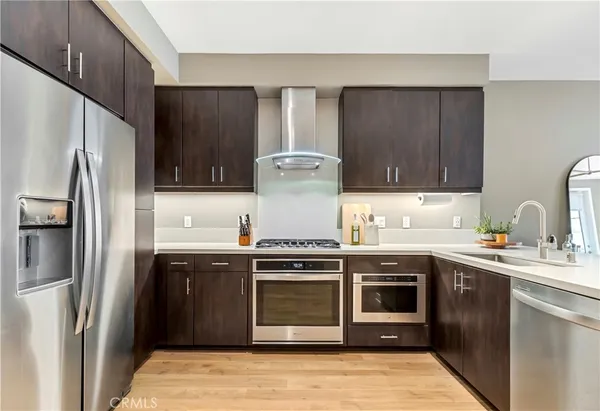 a kitchen with stainless steel appliances granite countertop a stove a refrigerator and a sink