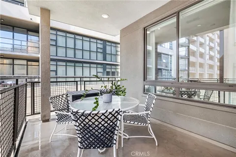 a dining room with furniture a rug and a large window