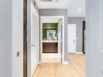 a view of a hallway view with wooden floor and living room