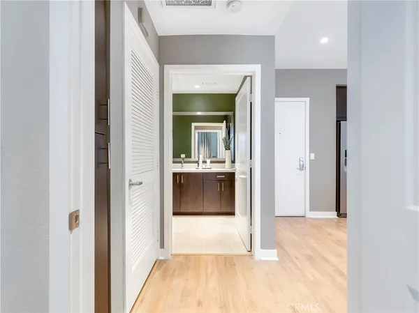 a view of a hallway view with wooden floor and living room
