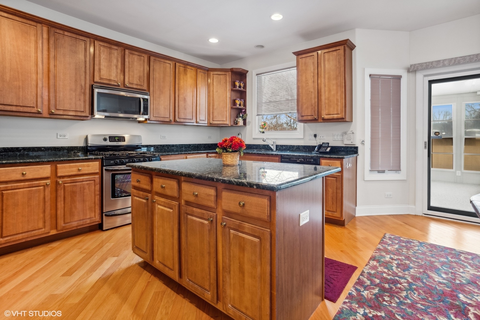 1034 East Woodrow Avenue Lombard, IL 60148 - Photo 11 of 36 a kitchen with stainless steel appliances granite countertop a stove a sink dishwasher and a microwave oven with cabinets