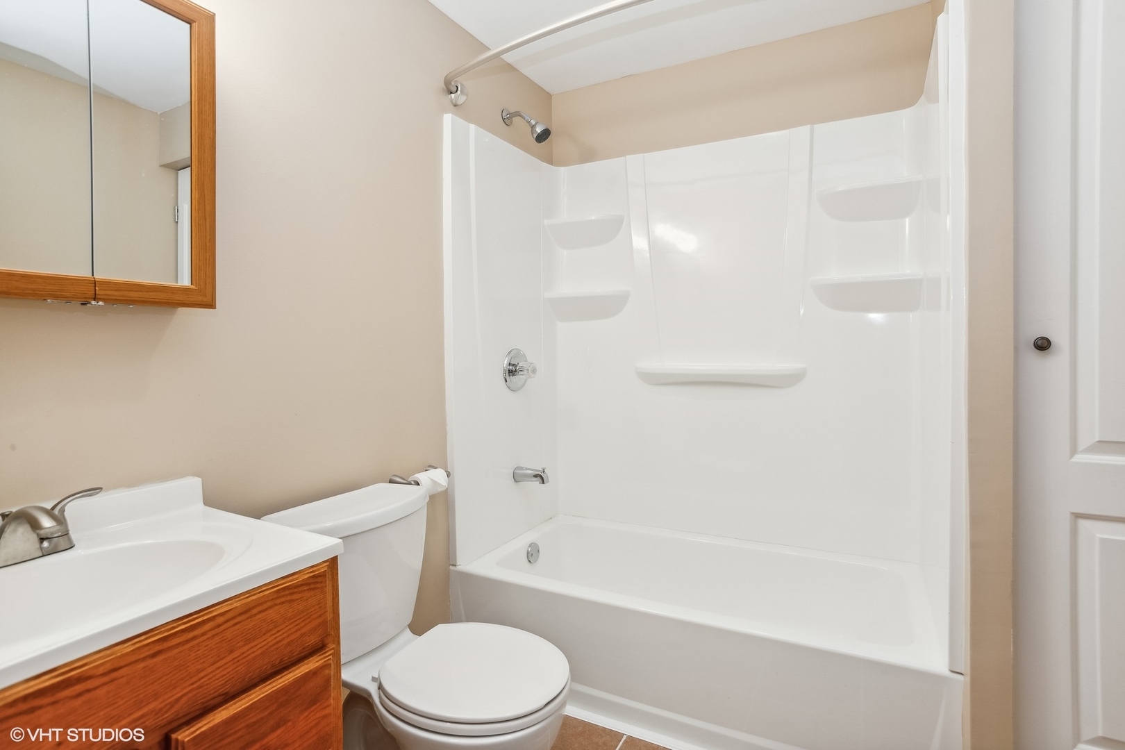 1034 East Woodrow Avenue Lombard, IL 60148 - Photo 28 of 36 a white toilet sitting next to a bath tub shower