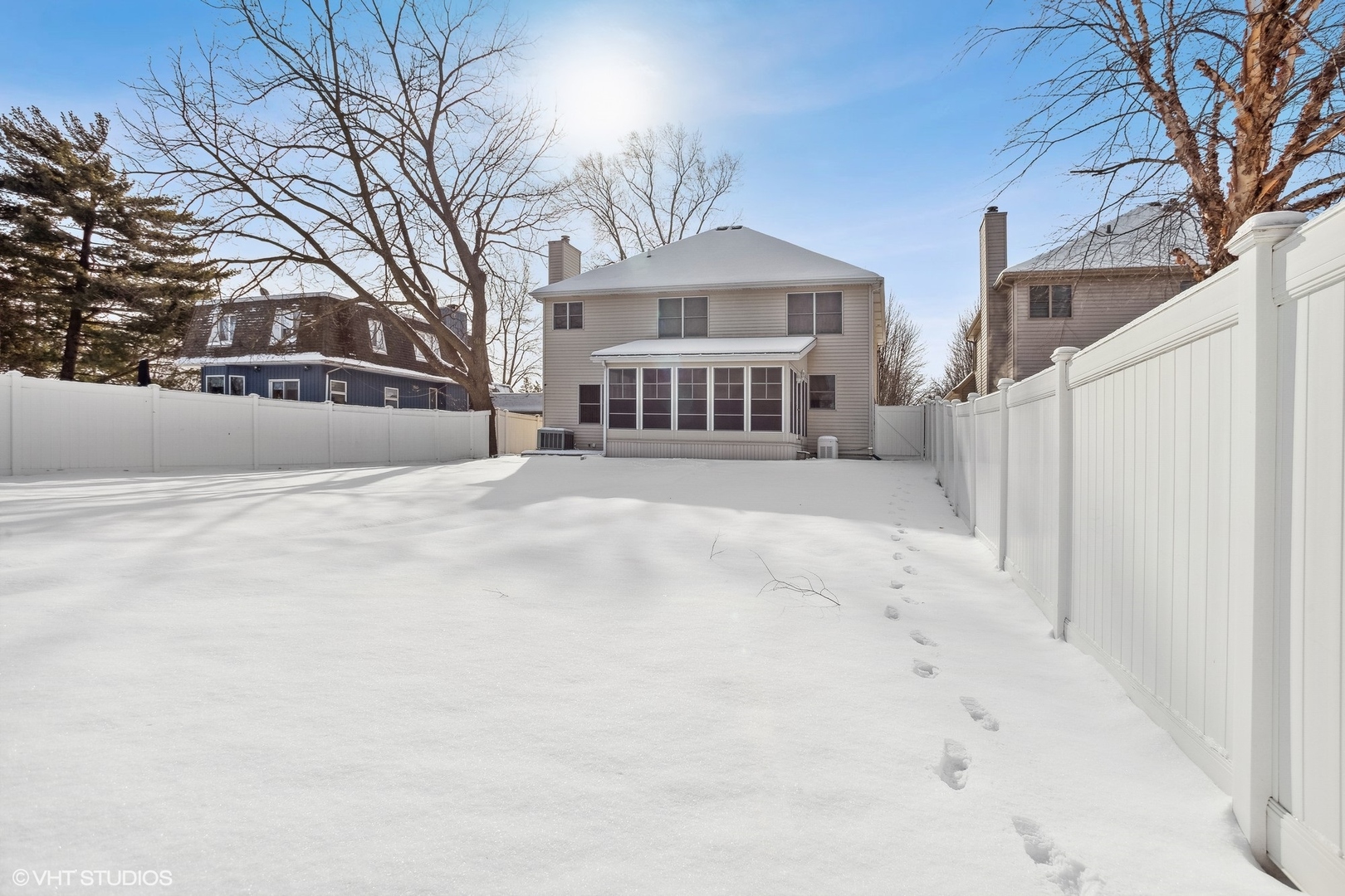1034 East Woodrow Avenue Lombard, IL 60148 - Photo 30 of 36 a view of a white house with a yard covered in snow