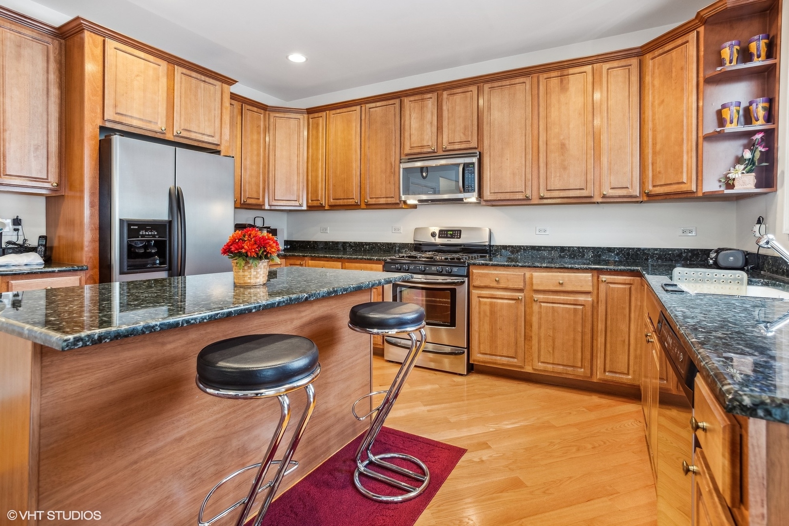 1034 East Woodrow Avenue Lombard, IL 60148 - Photo 9 of 36 a kitchen with stainless steel appliances granite countertop a sink a stove and a refrigerator