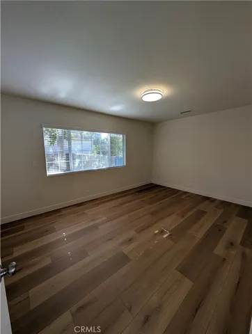 wooden floor in an empty room with a fireplace