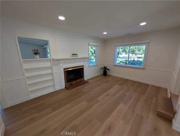 a kitchen with stainless steel appliances granite countertop a refrigerator a stove and a sink