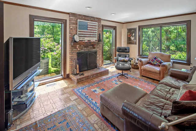 a living room with furniture a window and a fireplace