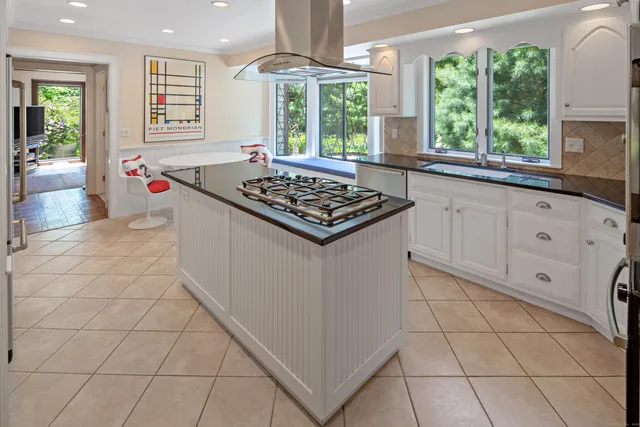 a kitchen with a stove a sink a refrigerator and window