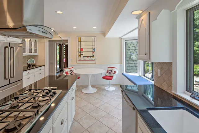 a kitchen with a stove a sink and a refrigerator