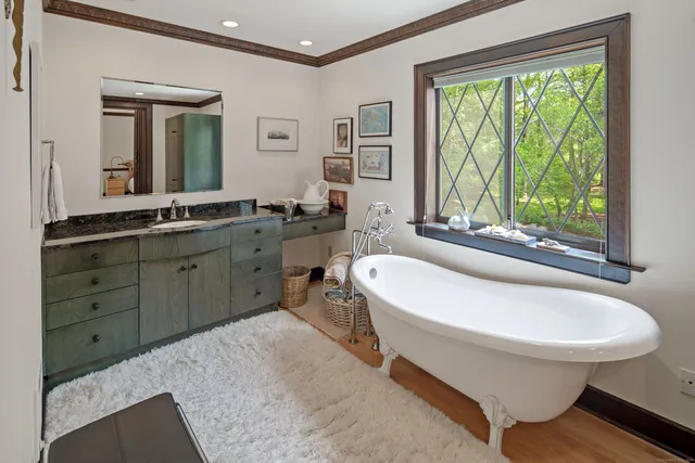 a spacious bathroom with a granite countertop sink and a large mirror