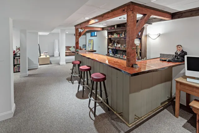 a room with table chairs and mirrors