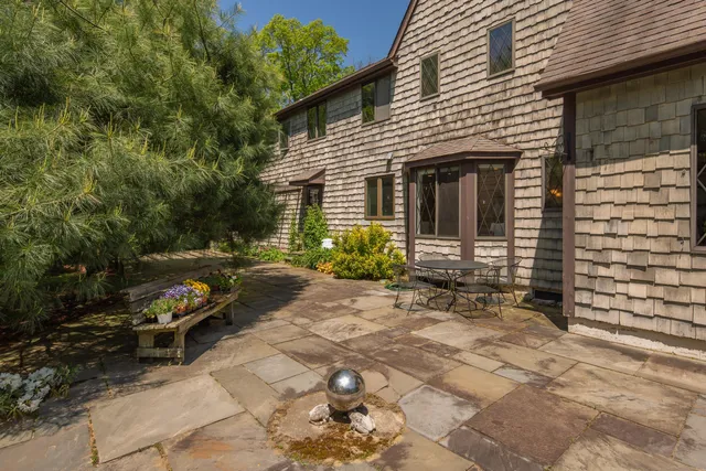 a view of a house with backyard and sitting area