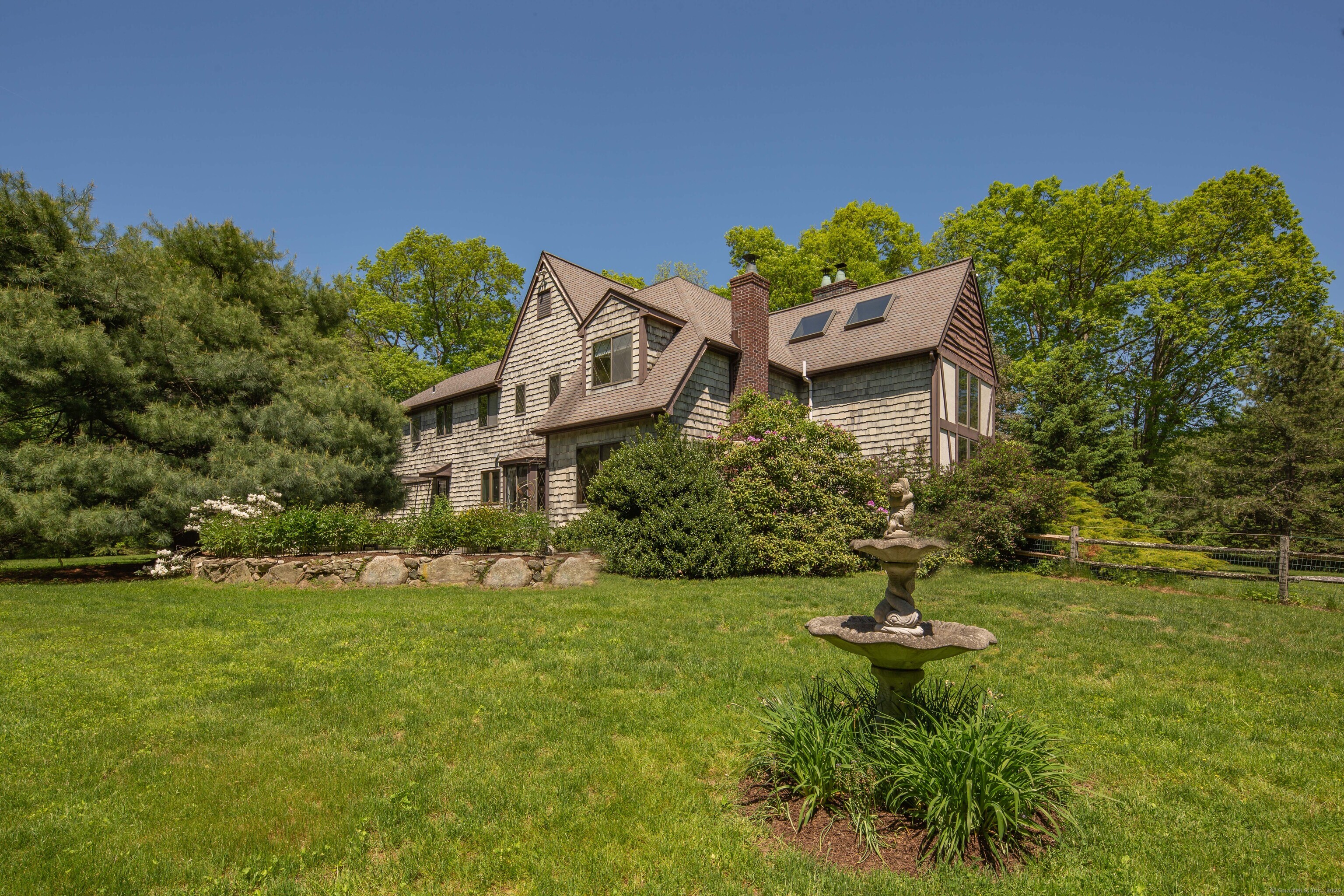 15 Tunxis Trail Redding, CT 06896 - Photo 27 of 27 a view of a house with a yard and sitting area