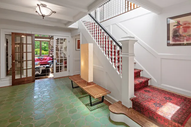 a living room with furniture and a stairs