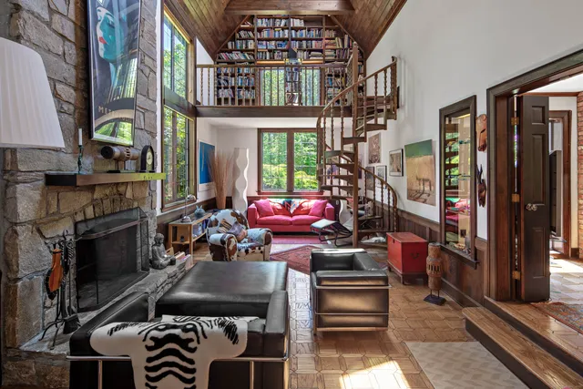 a room with furniture a chandelier and a fireplace