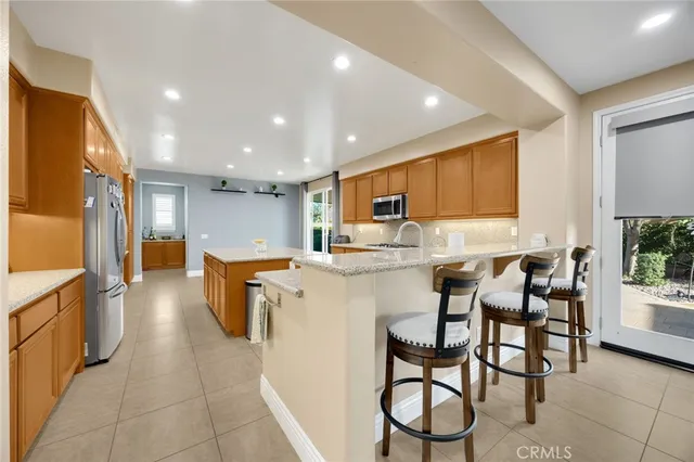 a kitchen with a table chairs refrigerator and cabinets