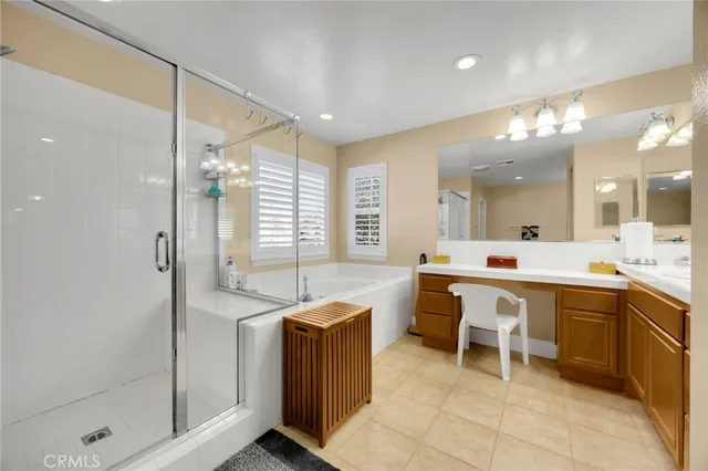 a large bathroom with a large mirror vanity and shower