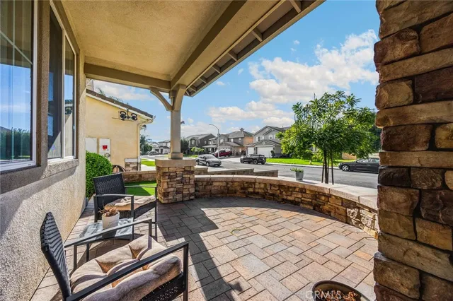 a living room with patio furniture and a fireplace