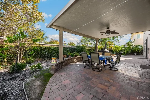 a view of a patio with table and chairs under an umbrella