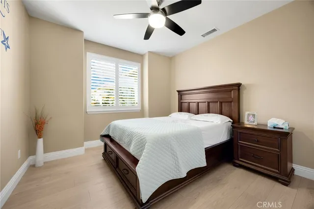 a spacious bedroom with a bed and a ceiling fan